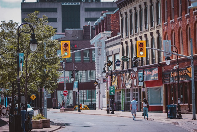 Two people walking in downtown St. Catharines, Ontario during the day.