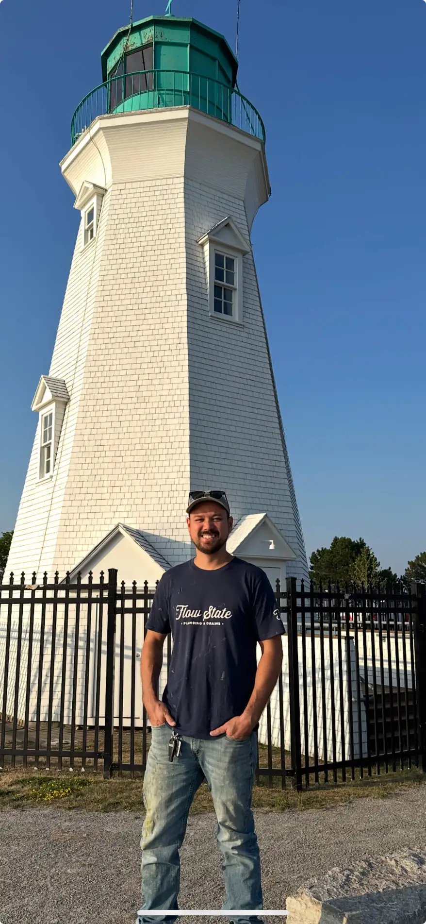 Smiling niagara region plumber standing in front of the Port Dalhousie light house in St. Catharines