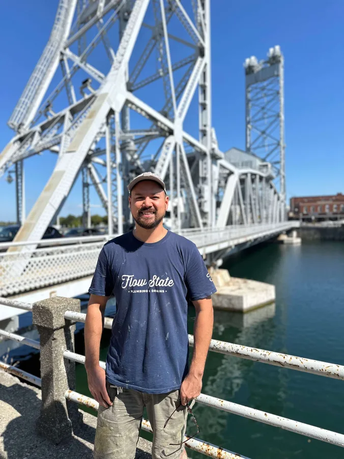 A plumber standing in front of the East Main bridge in Welland.
