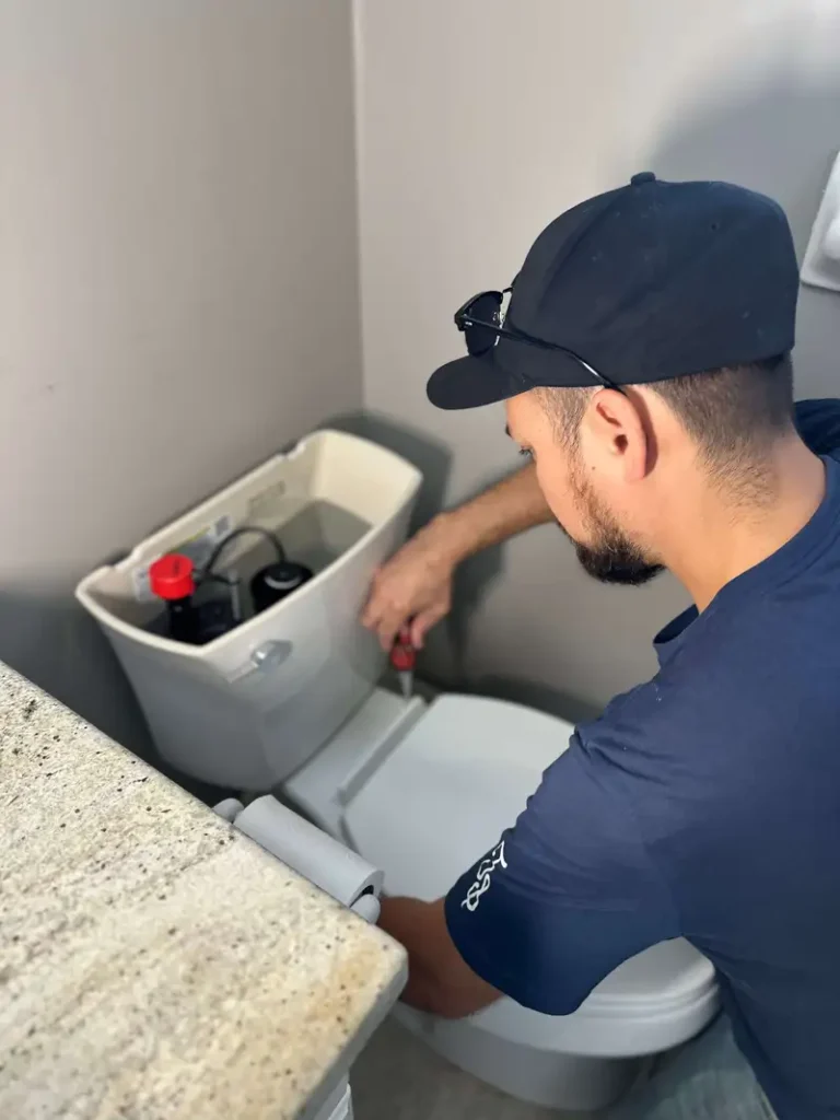 A plumber in Port Colborne installing a new toilet 